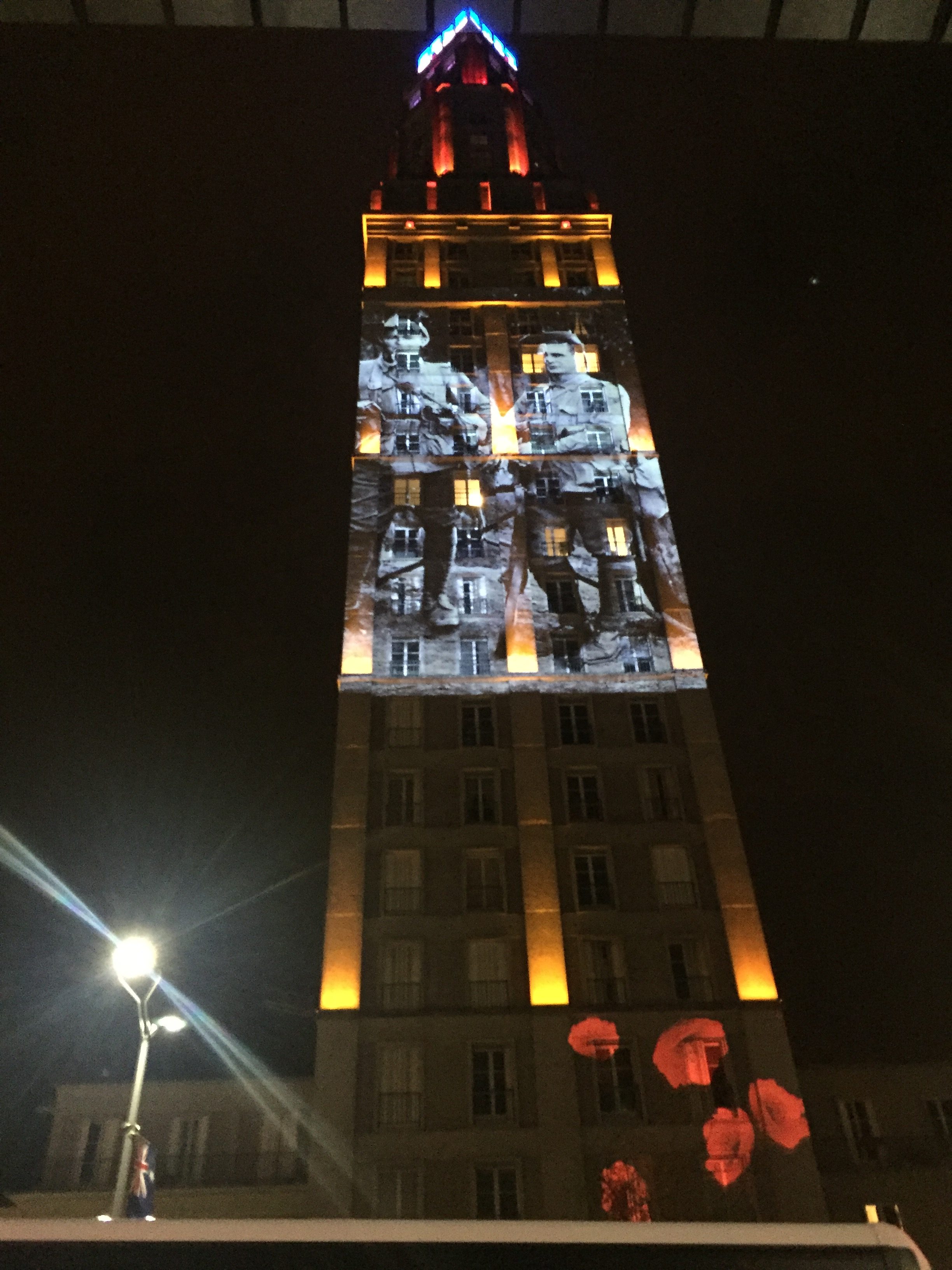 Black and white photos of young Australian soldiers projected onto buildings in the French town of Amiens