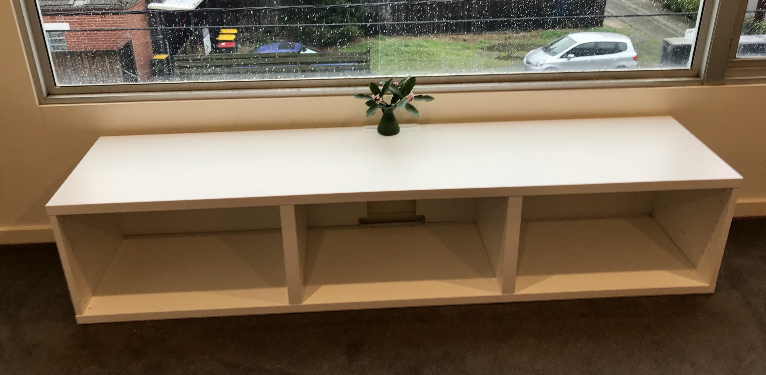 Side unit in front of a large window