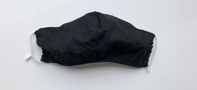 Black face mask on a white surface