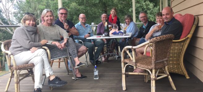 A family group sits arouid a table